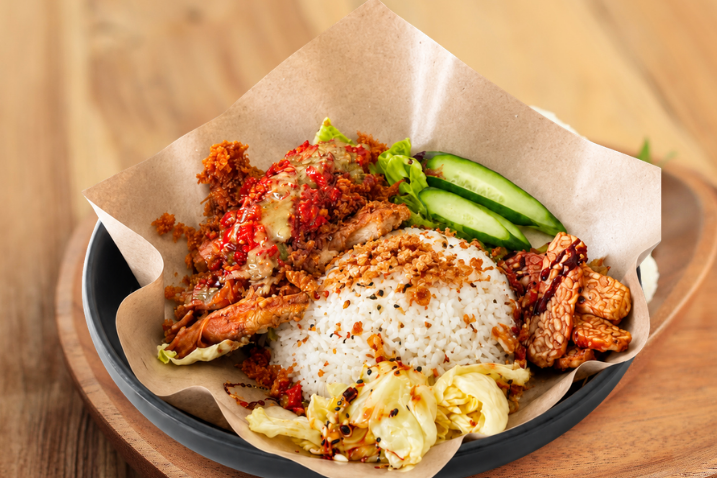 Vegan Ayam Gepuk set in Melbourne: crispy smashed vegan chicken schnitzel, sambal, tempeh, cucumber and rice